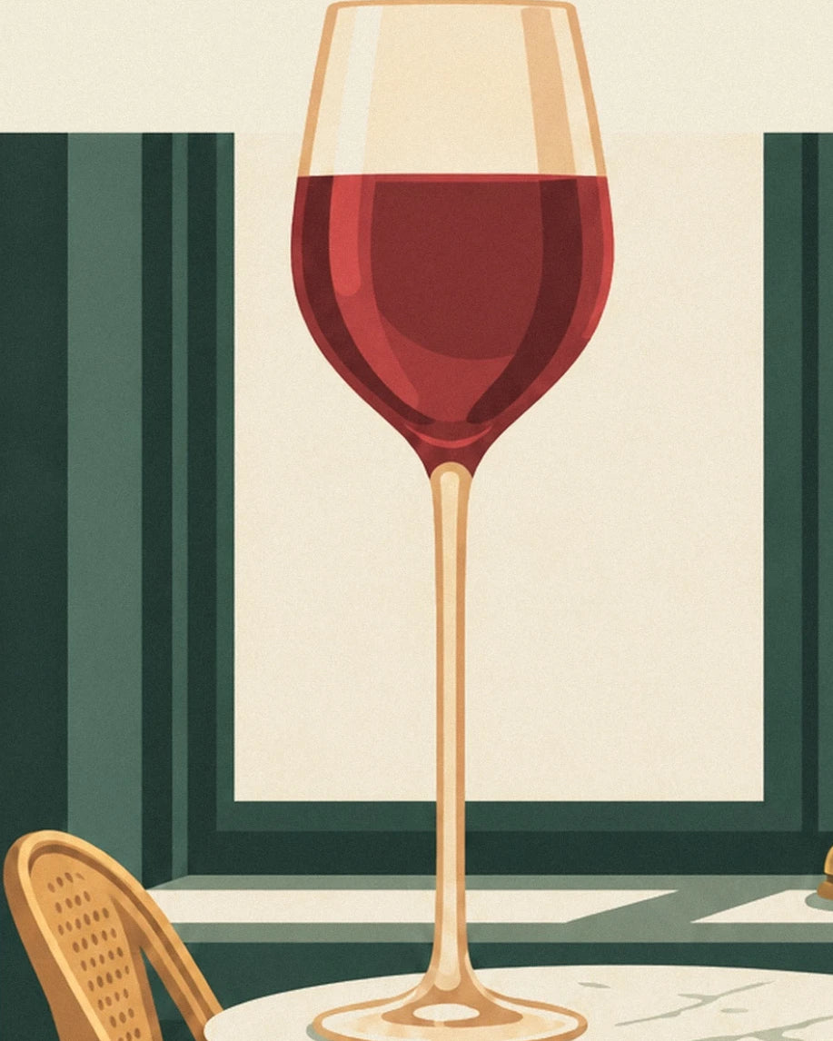 A glass of red wine with a long golden stem in front of the bistro’s green wood panelling