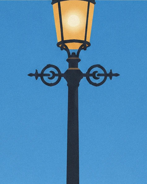 A black street lamp with decorative scrollwork and a golden lantern against a blue background