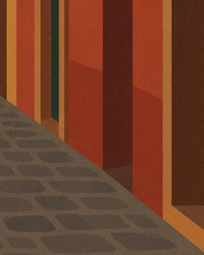 The grey cobbles of the narrow street and the orange and rusty-brown façades