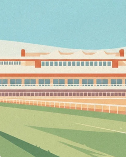 The grandstand with cream and orange façades, behind the white track rails