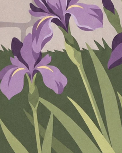 Purple irises with yellow touches among the garden's long pointed leaves