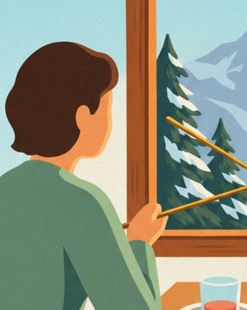 A diner in a green jumper, fork in hand, facing the snowy fir trees outside the window