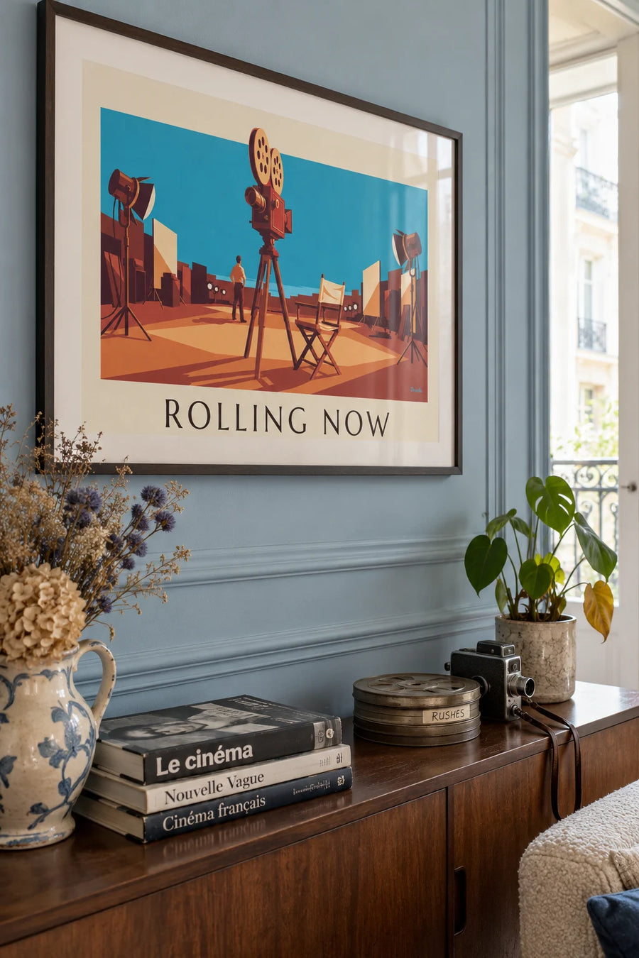 Movie camera on its tripod on a film set poster: framed on the wall