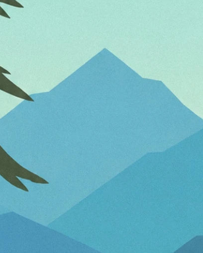 The mountains in shades of blue beneath a pale green sky, framed by pine branches