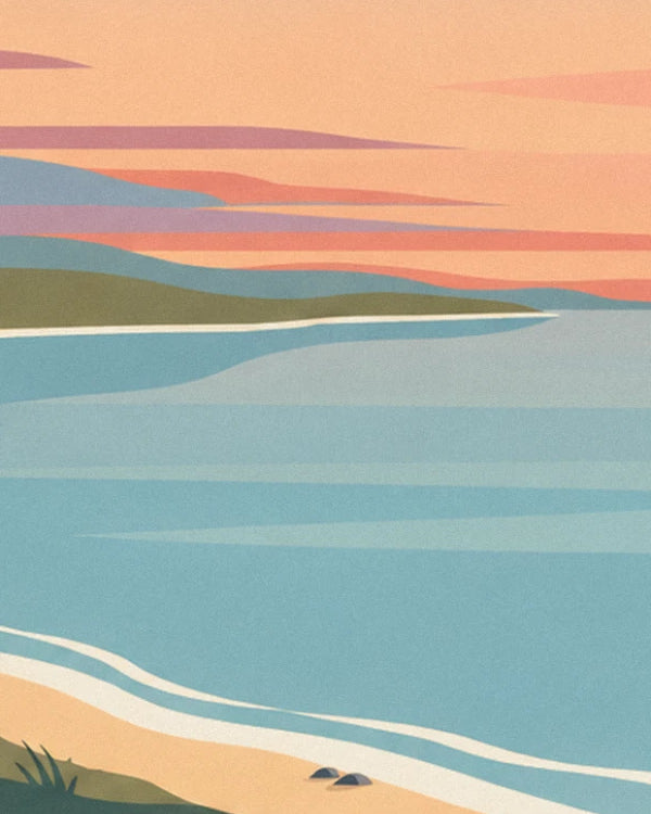 The shore at sunset, with blue sea, a white wave and golden sand with 2 pebbles