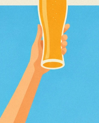 A hand raising a glass of golden beer against the blue sky