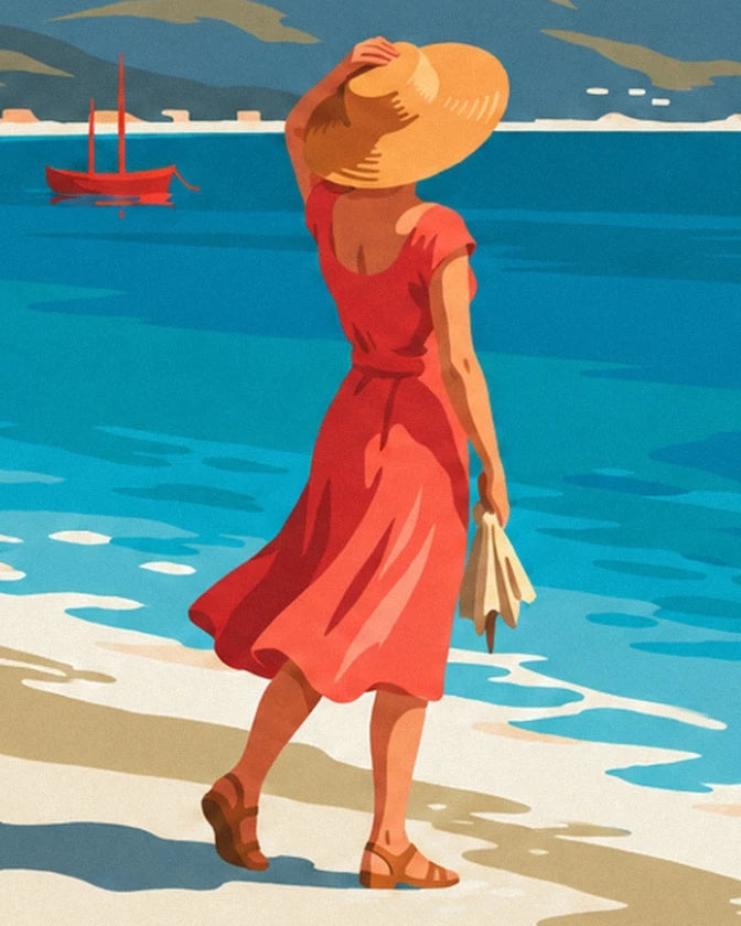 A woman in a red dress and straw hat on the beach, facing the red sailing boat