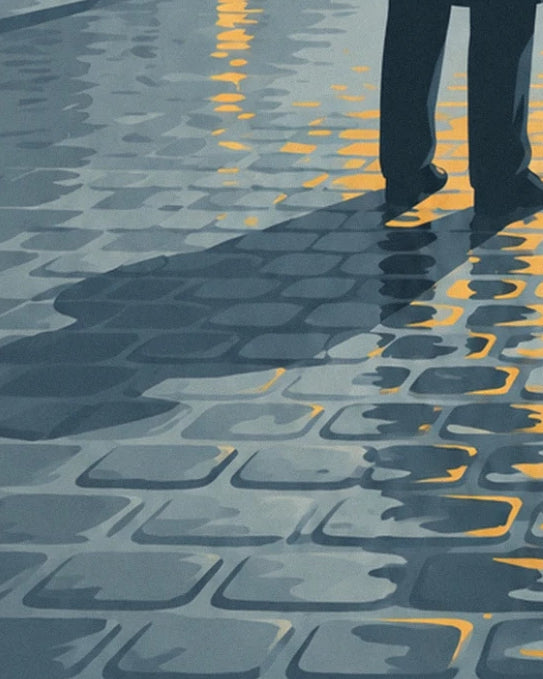 The feet of a man in a dark suit and his long shadow on the wet cobbles, with yellow reflections