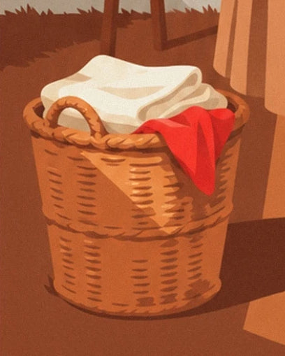 Le panier tressé rempli de linge blanc, avec un tissu rouge sur le bord