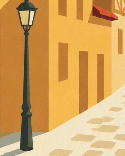 Le lampadaire vert sombre devant une façade ocre, au bord de la ruelle pavée claire