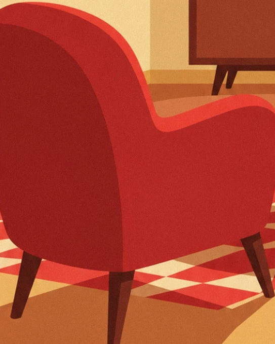 The rounded red armchair on the rug with geometric patterns