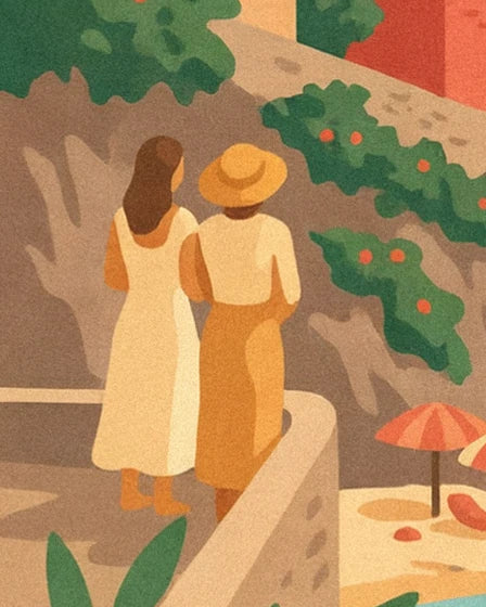 A couple seen from behind, with a white dress and straw hat, on the low wall above the beach